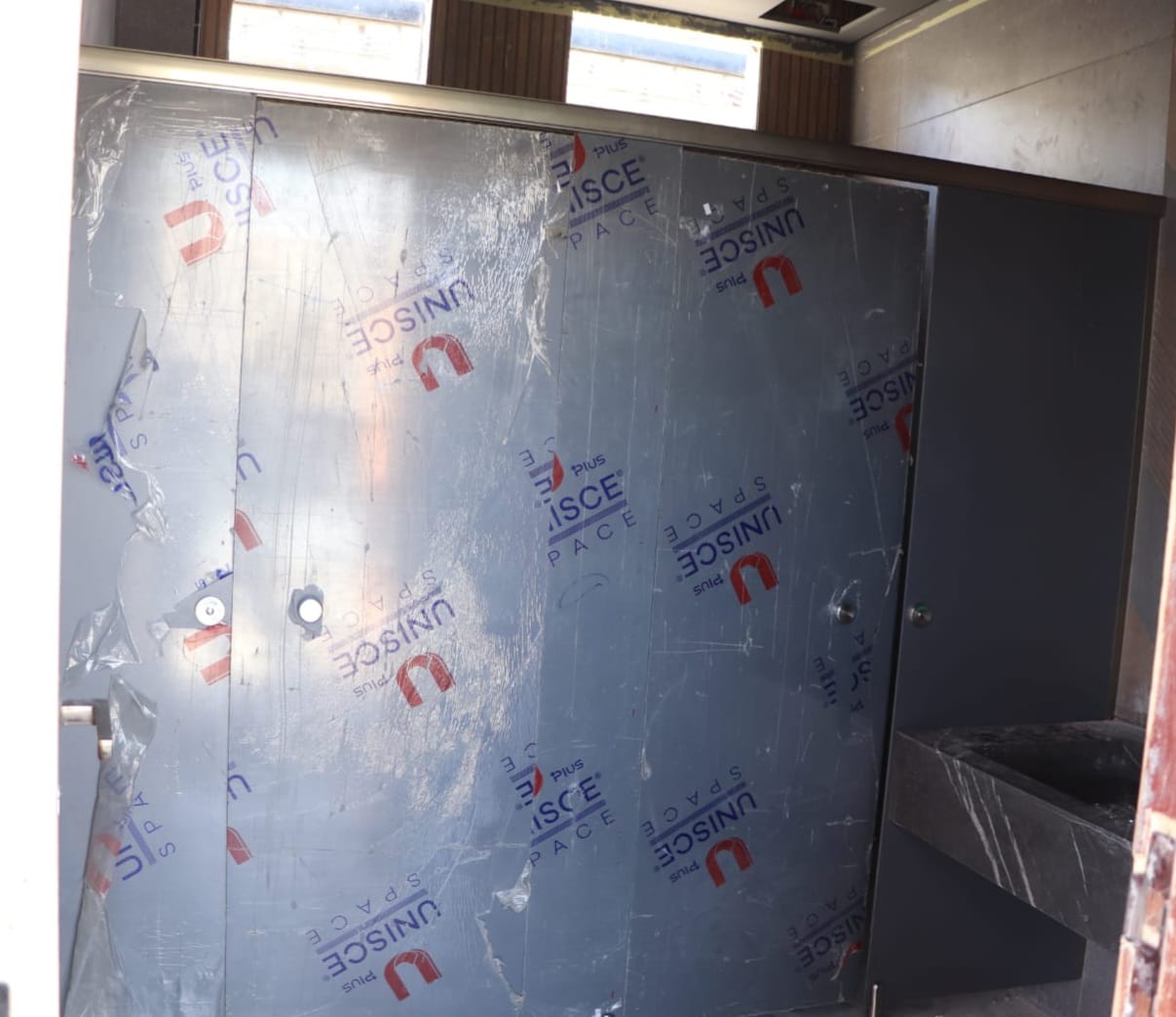 UNISCE compact HPL panel detail on a washroom project in the First Settlement