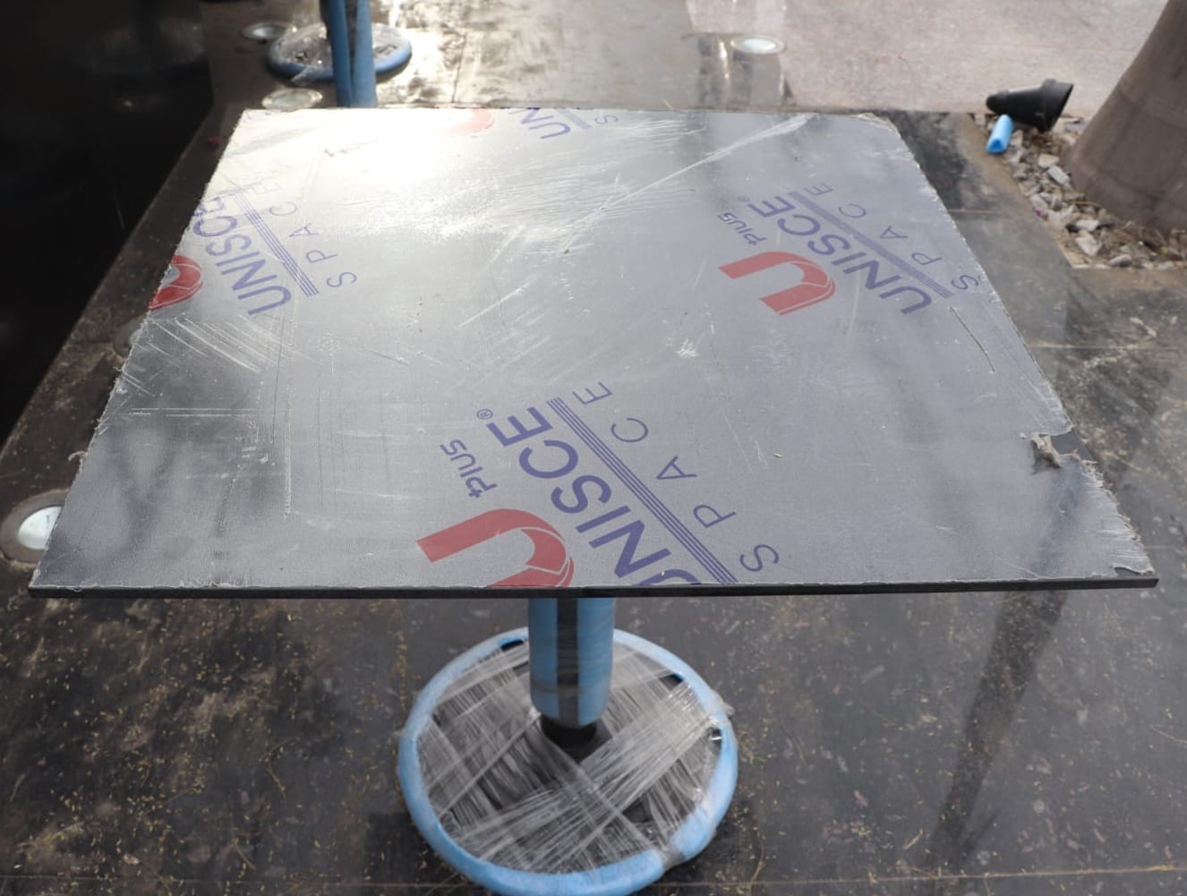 Cafe table top in Corian solid surface installed by Cairo House across Cairo, made from JAICAN acrylic that resists coffee, red wine and cleaning agents, with light scratches sanded out on site rather than the table being replaced like laminate.