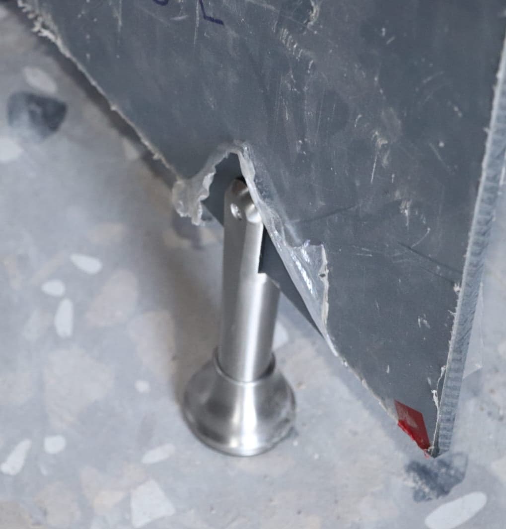 Close-up of stainless steel support used in Cairo House bathroom partition installation, showing HPL compact details from a construction materials supplier Cairo businesses use for strong restroom systems.