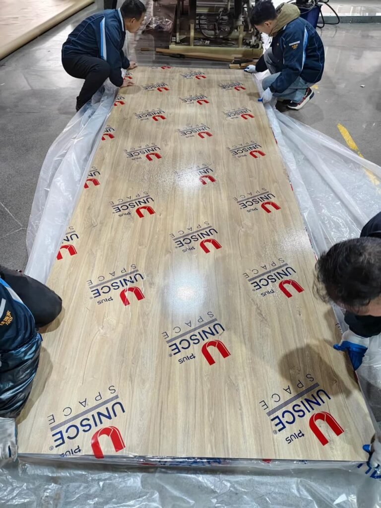 Large HPL compact panel being prepared for installation by Cairo House كايرو هاوس, a construction materials supplier Cairo and New Nozha businesses work with for bathroom partitions and project materials.