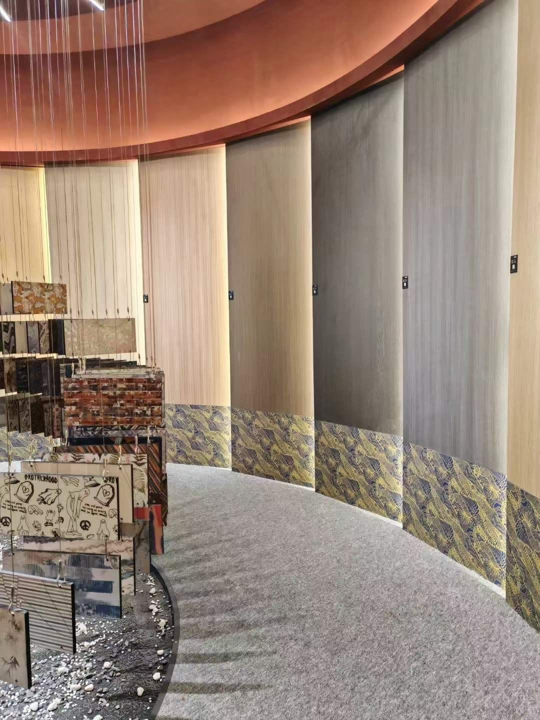 Curved showroom wall finished in wood grain and patterned compact HPL panels, showing how the cladding shapes feature walls. Cairo House in New Nozha, Cairo supplies Compact HPL in Cairo for offices, hotels and retail interiors.