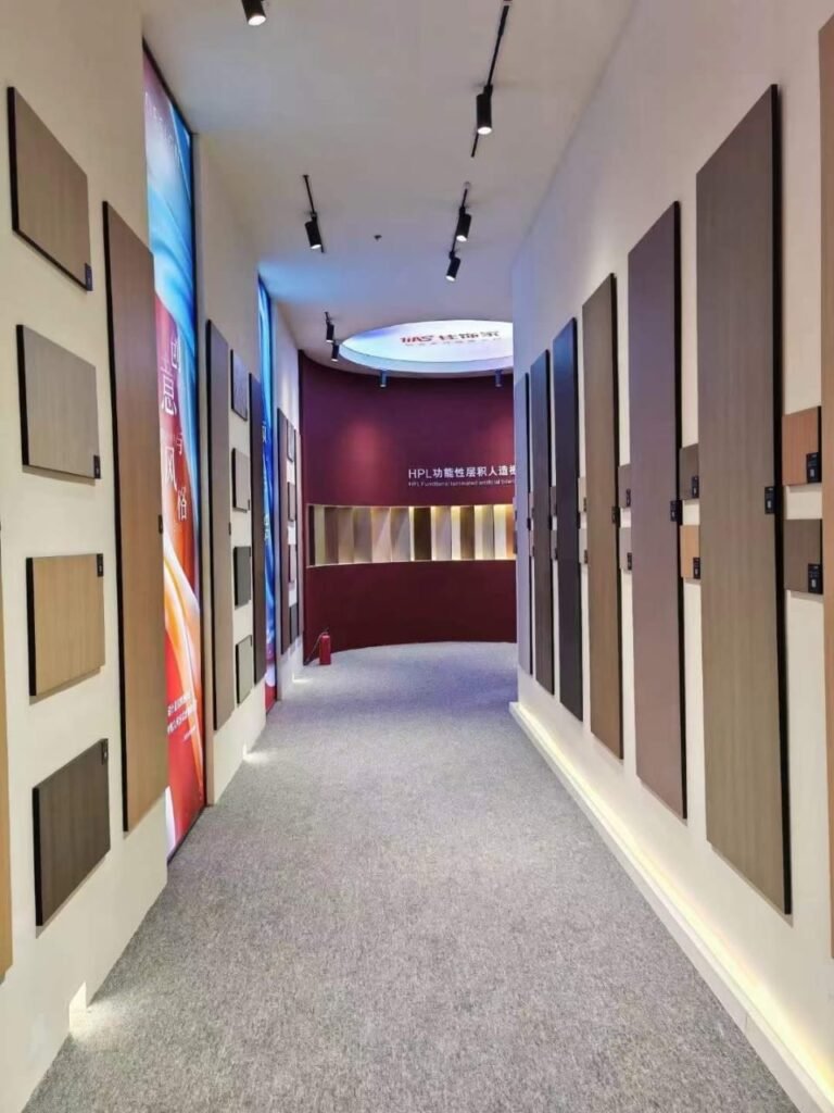 Corridor of compact HPL sample panels mounted on both walls, showing wood, stone and solid colour finishes. Cairo House supplies and installs Compact HPL in Cairo for offices, clinics, hotels and residential fit out projects across the city.