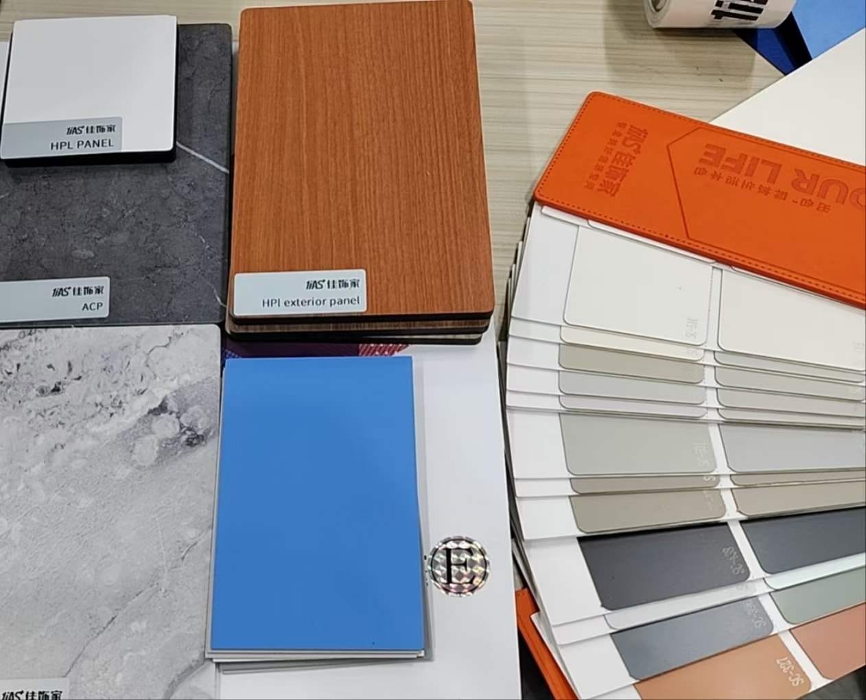Compact HPL panel, exterior HPL and ACP samples laid out beside a colour swatch book at Cairo House in New Nozha, Cairo. The spread helps clients compare Compact HPL in Cairo finishes and grades for interior and exterior fit out.