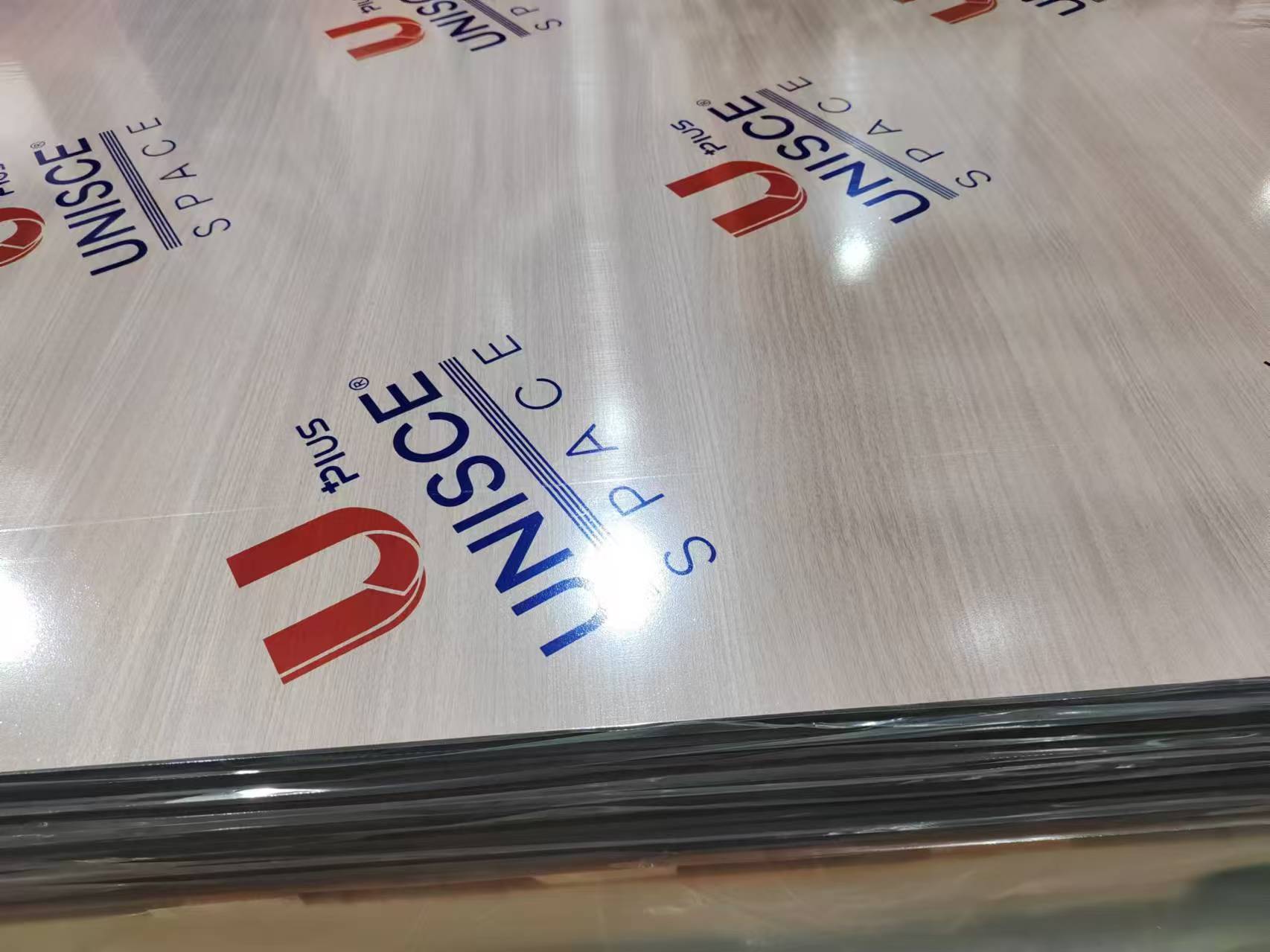 Stack of white oak grain compact HPL sheets with protective film, supplied by Cairo House in New Nozha, Cairo. These high pressure laminate panels are used for cladding, partitions and joinery by contractors sourcing Compact HPL in Cairo.
