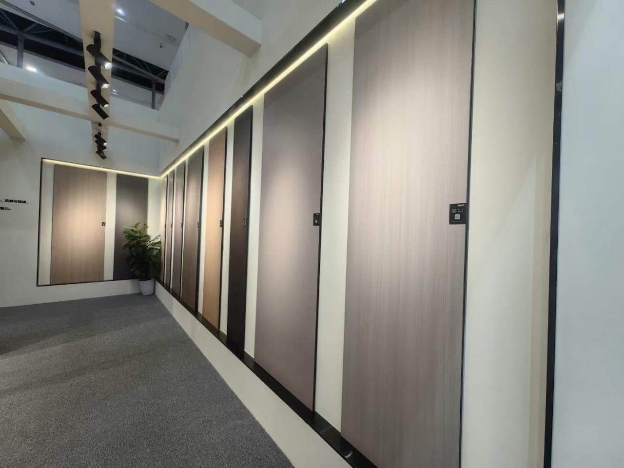 Display wall of wood grain compact HPL panels in light and dark tones, showing finishes offered by Cairo House. Clients comparing Compact HPL in Cairo view real panels before choosing colour, texture and thickness for walls, doors and partitions.