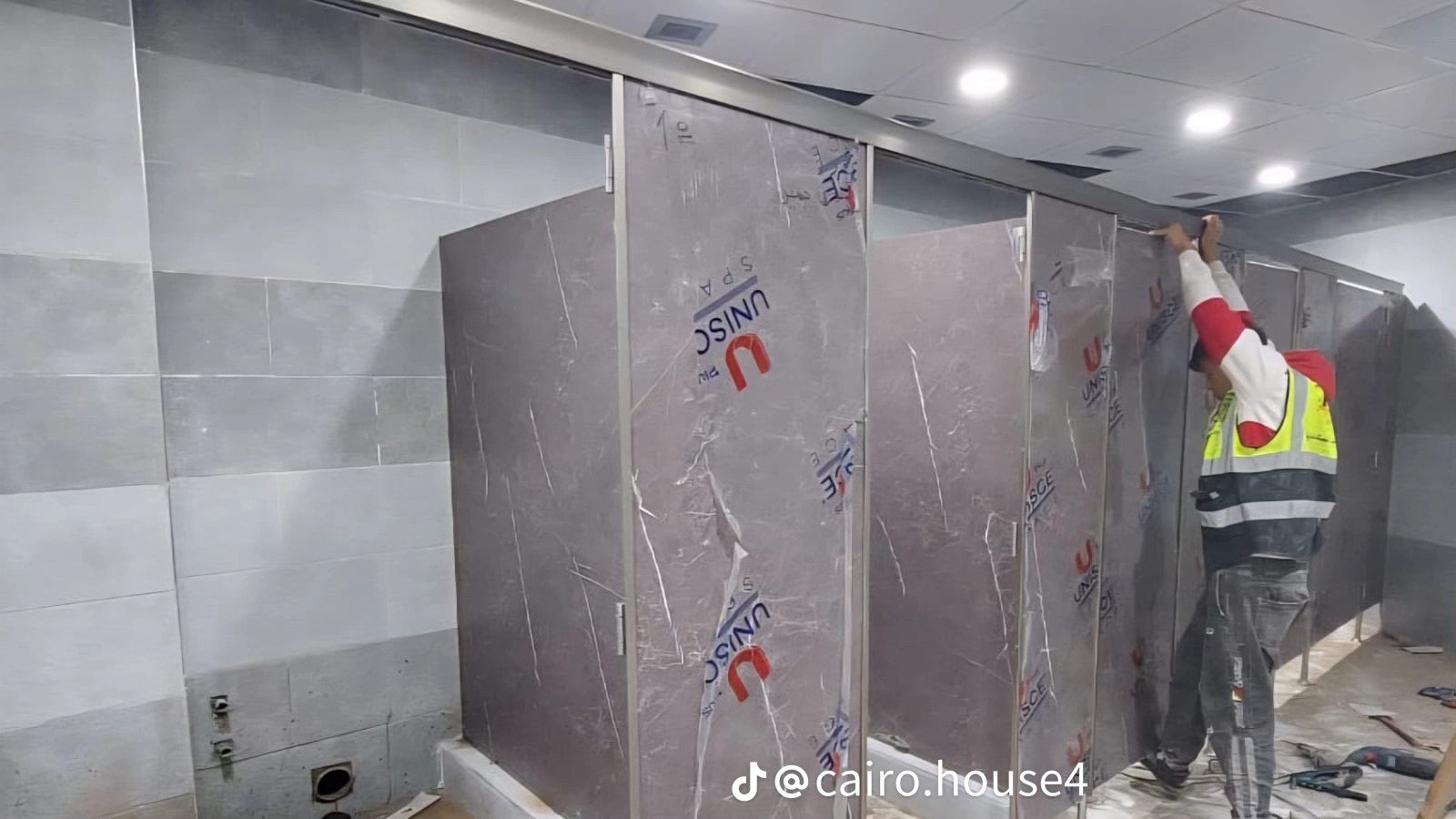 Marble finish compact HPL panels during partition installation in Cairo