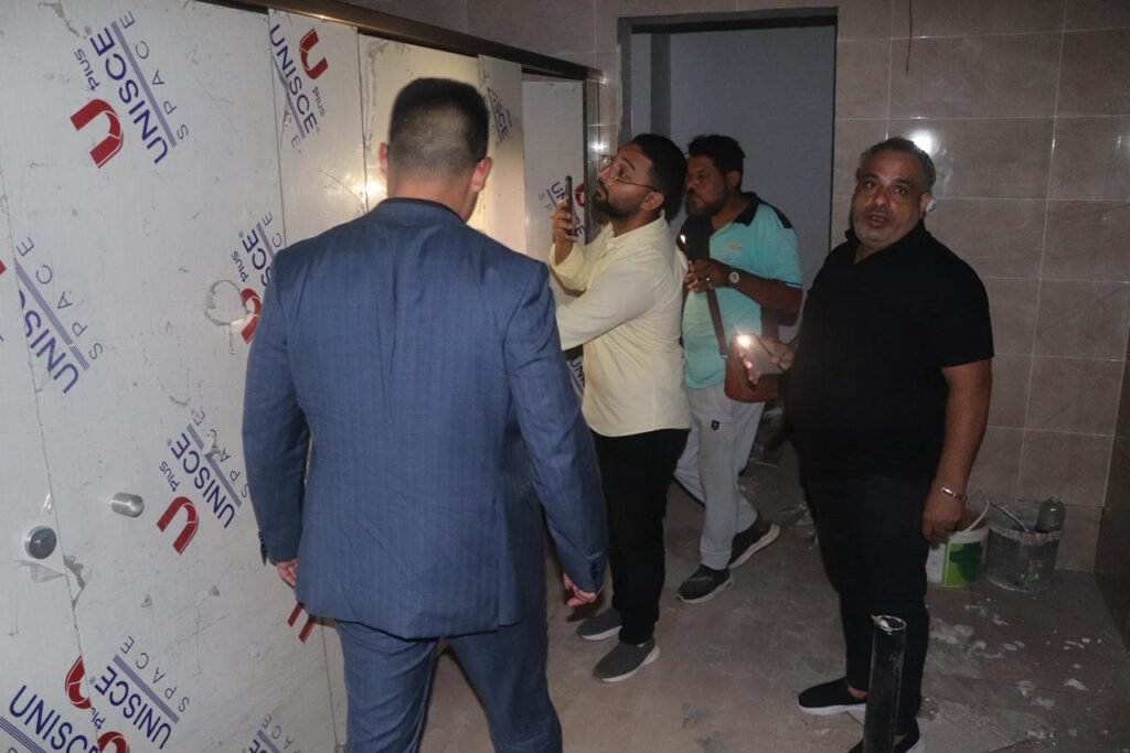 Cairo House inspecting UNISCE compact HPL cubicle panels on site.