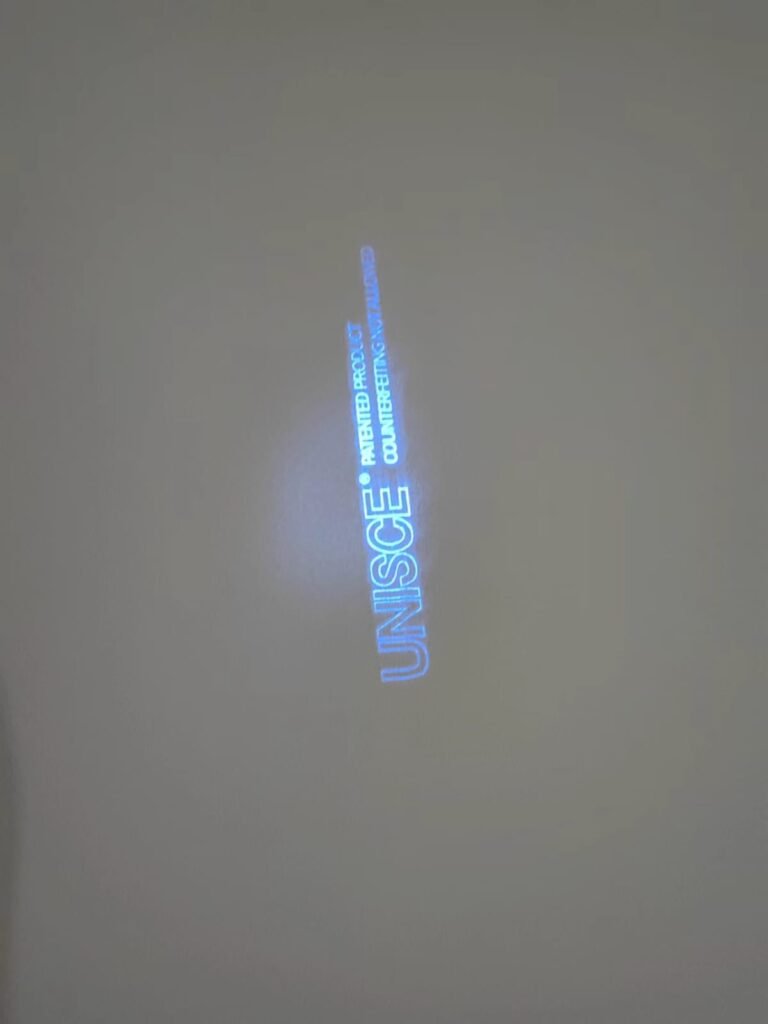 UNISCE authentication text under UV light on compact HPL