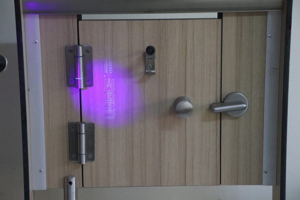 Stainless hinge and UNISCE UV mark on compact HPL partitions