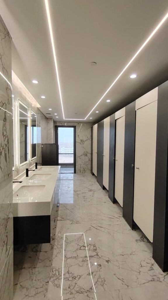 Finished washroom in Cairo with compact HPL partitions, marble vanity tops and full height mirrors. Cairo House supplies and installs UNISCE compact HPL bathroom partitions that hold up to daily commercial cleaning in Cairo.
