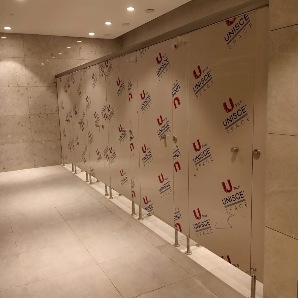 A long row of sand coloured compact HPL partitions in Cairo, still filmed and awaiting handover. Cairo House delivers UNISCE compact HPL bathroom partitions for hotels, malls, schools and factories throughout Cairo.