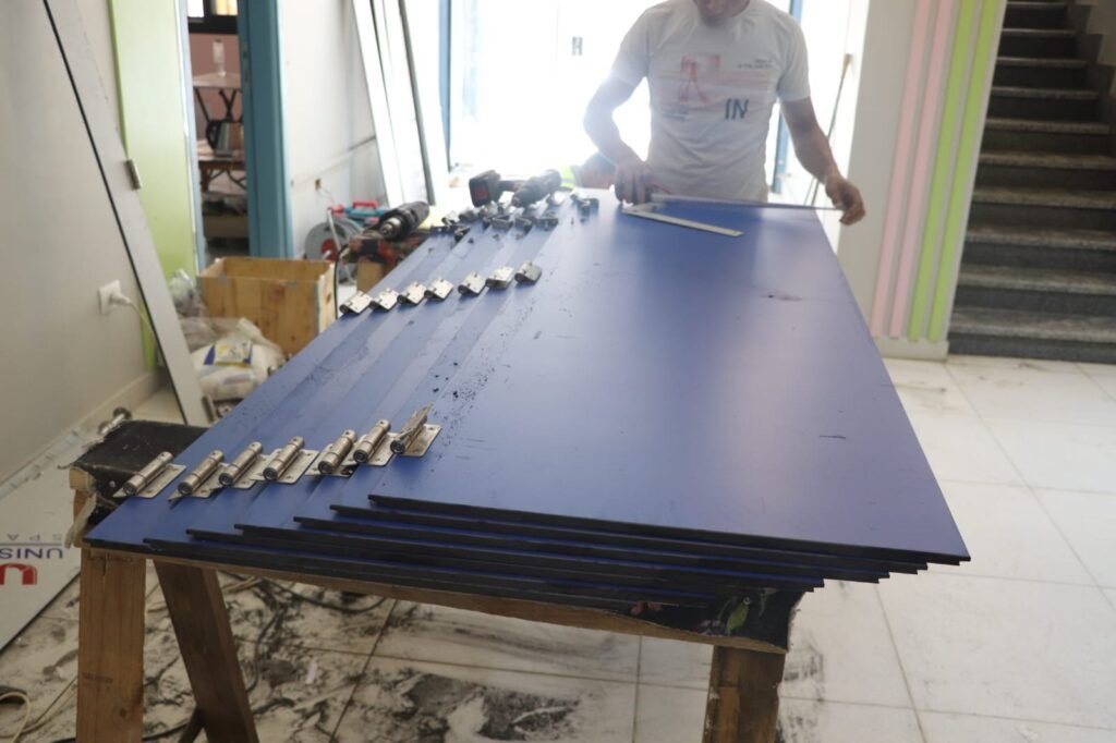 Navy blue panels and stainless hardware staged for compact HPL partitions in Cairo. Cairo House supplies the board, the hinges, the locks and the brackets for every compact HPL bathroom partition job it takes on in Cairo.